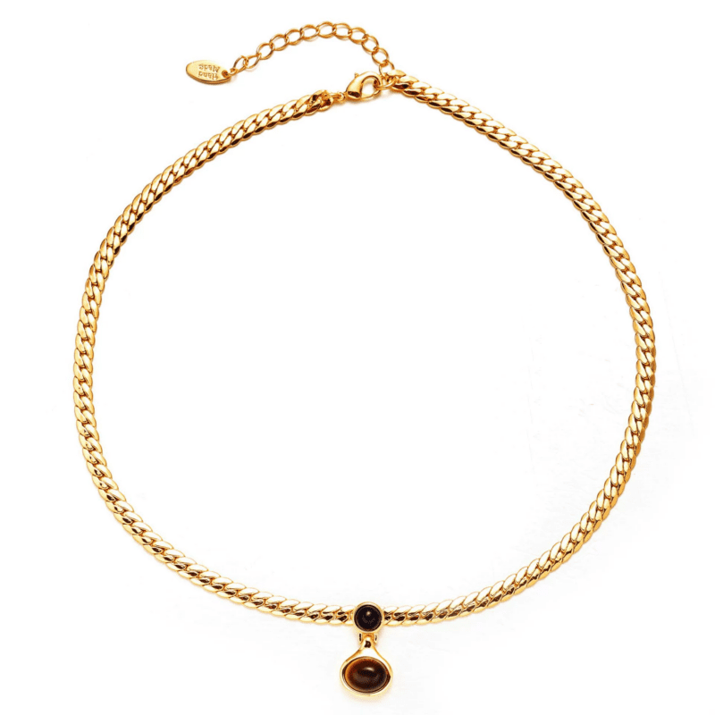 LIVKE’s gold tiger eye oval pendant on a snake chain, styled with a linen dress for boho-chic everyday elegance.
