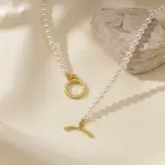 LIVKE’s irregular freshwater pearl necklace on a gold chain, styled with a beige sweater for minimalist everyday elegance.