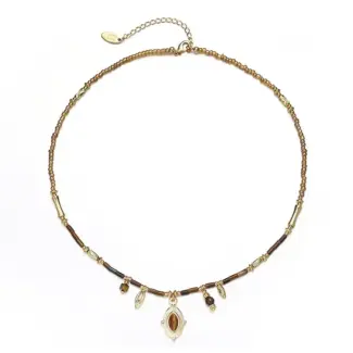 LIVKE’s oval tiger eye necklace with 18K gold-plated chain, styled with black sweater for minimalist elegance.