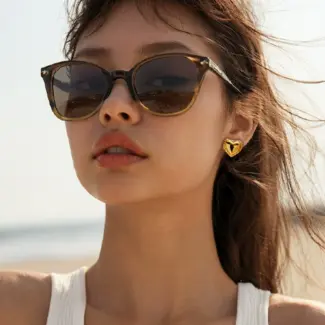 LIVKE’s gold textured heart stud earrings with crinkle details, styled with a white blouse for minimalist office elegance.
