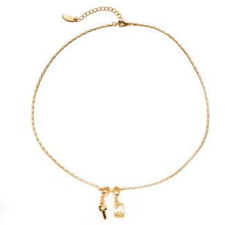 Close-up of LIVKE’s electroplated 18K gold brass zircon stone necklace with a round lock clasp, styled over a chic neckline.