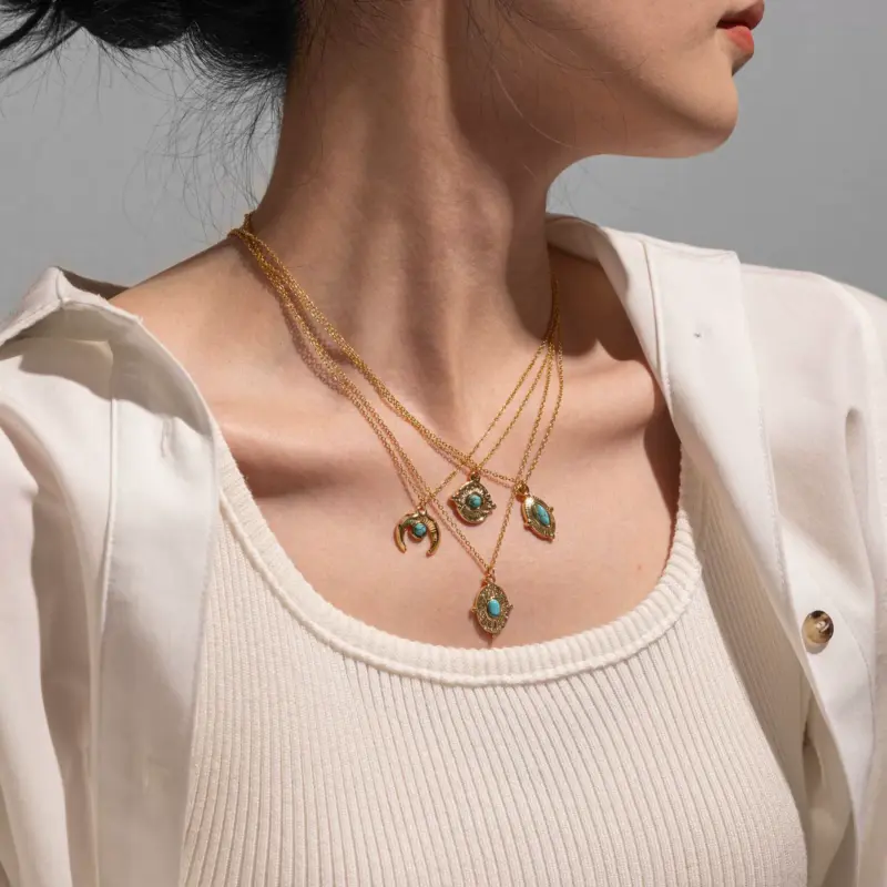 LIVKE’s gold oval bead necklace with intricate vintage texture, styled with a black evening gown for royal-inspired elegance.