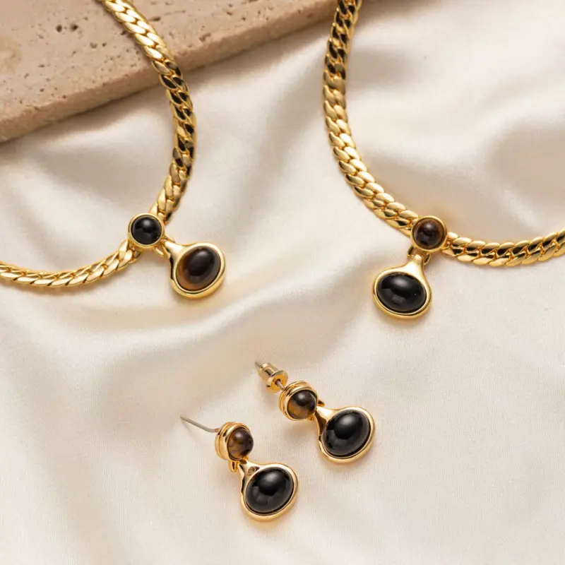 LIVKE’s gold tiger eye oval pendant on a snake chain, styled with a linen dress for boho-chic everyday elegance.