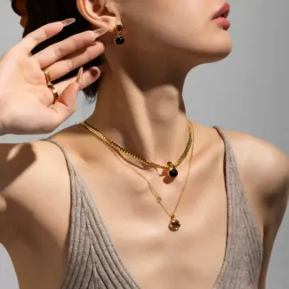 LIVKE’s gold tiger eye oval pendant on a snake chain, styled with a linen dress for boho-chic everyday elegance.