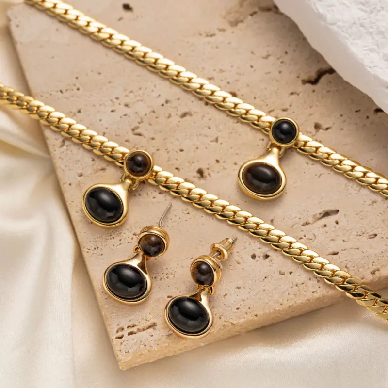 LIVKE’s gold tiger eye oval pendant on a snake chain, styled with a linen dress for boho-chic everyday elegance.