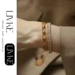 LIVKE’s gold bold chain bracelet with cubic zirconia, styled with a blazer and watch for power office elegance.
