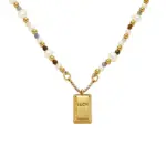 LIVKE’s gold French vintage ‘Luck’ pendant necklace with pearl drop, styled with a white blouse for office elegance.