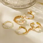 Vintage freshwater pearl set in 18K gold filigree band, styled with lace gloves for bridal elegance.