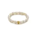 Vintage freshwater pearl set in 18K gold filigree band, styled with lace gloves for bridal elegance.