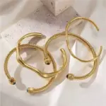 LIVKE’s minimalist gold adjustable bangle bracelet styled with a white button-up for office elegance.