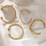 LIVKE’s minimalist gold adjustable bangle bracelet styled with a white button-up for office elegance.