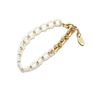 LIVKE’s gold pearl chain bracelet styled on a wrist with a linen sleeve for boho everyday elegance.