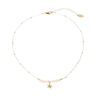 LIVKE’s layered pearl and shell necklaces styled with a white sundress and straw bag for beach-to-bar elegance.