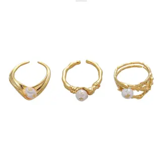 LIVKE’s gold leaf and pearl adjustable ring on a hand with neutral nails, styled with a linen dress for effortless boho elegance.