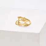 Personalized open-ended couple rings with engraved names "Alex & Sam" in 18K gold.