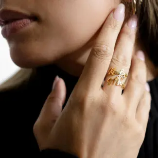 Personalized open-ended couple rings with engraved names "Alex & Sam" in 18K gold.