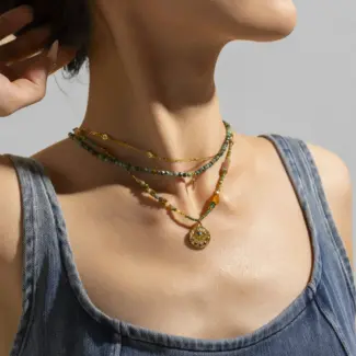 Adjustable LIVKE brass necklace with amethyst and turquoise beads layered over linen dress for bohemian everyday style.