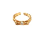 Eclectic woman stacking LIVKE gold textured rings on fingers while browsing vintage market, showcasing bohemian jewelry styling