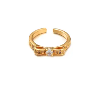 Eclectic woman stacking LIVKE gold textured rings on fingers while browsing vintage market, showcasing bohemian jewelry styling