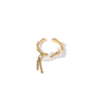 Hand wearing LIVKE adjustable pearl tassel ring at desert festival, showcasing boho jewelry with flowing movement