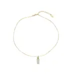 Woman wearing LIVKE green aventurine and white jade necklace with cashmere sweater, showcasing minimalist jewelry for urban elegance
