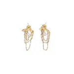 Gold knotted earrings with rainbow tassels on model dancing under club lights
