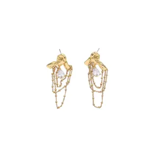 Gold knotted earrings with rainbow tassels on model dancing under club lights