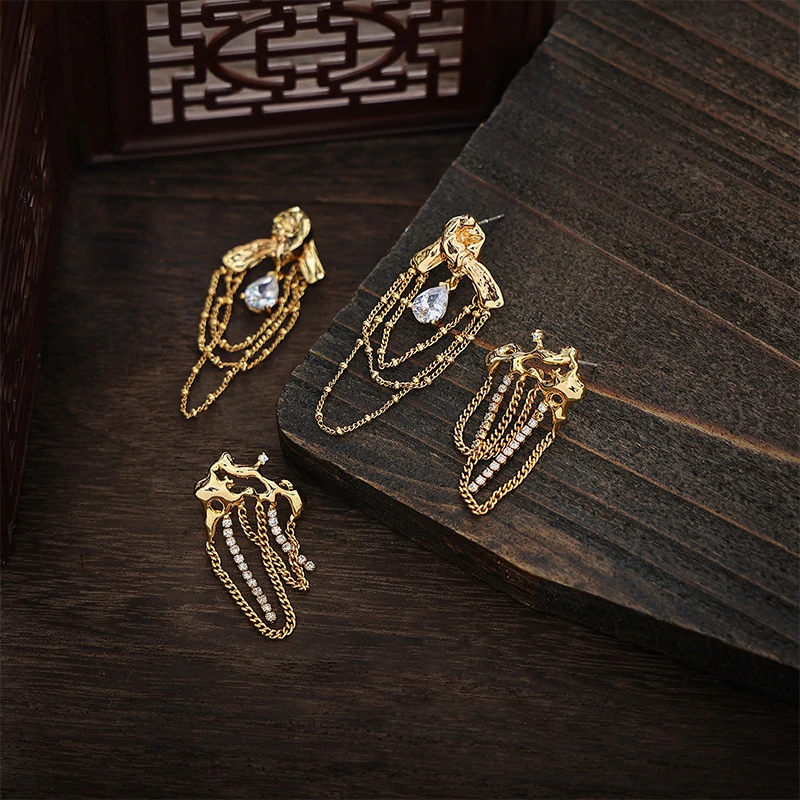 Gold knotted earrings with rainbow tassels on model dancing under club lights