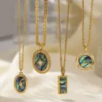 Layered oceanic necklaces on sand with seashells under sunset light