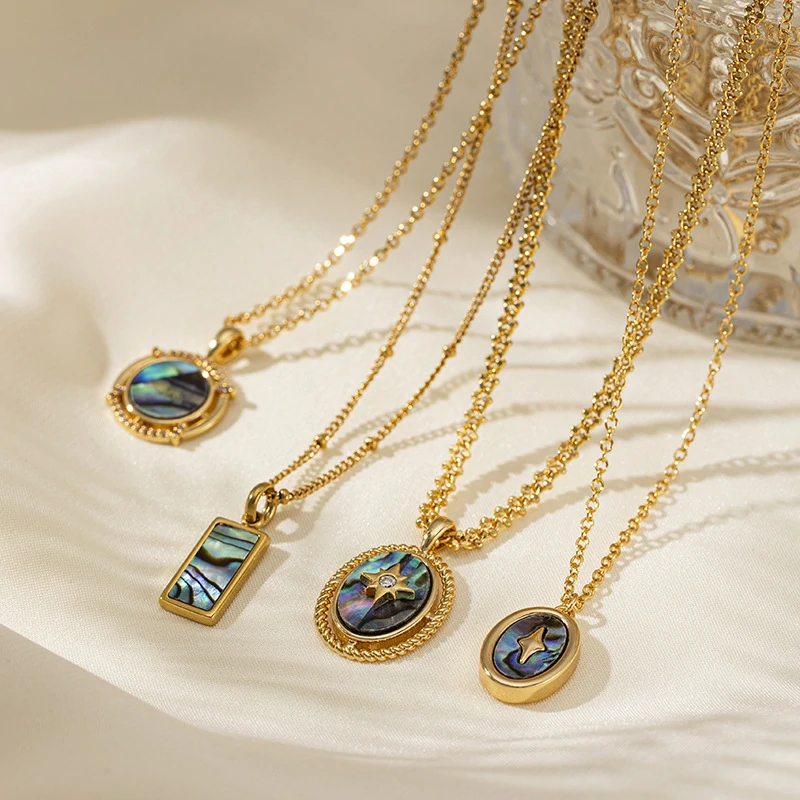 Layered oceanic necklaces on sand with seashells under sunset light