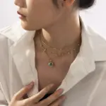 Layered oceanic necklaces on sand with seashells under sunset light