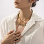Layered oceanic necklaces on sand with seashells under sunset light