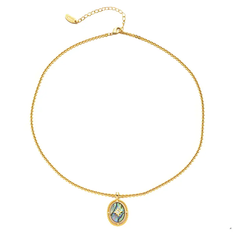Layered oceanic necklaces on sand with seashells under sunset light