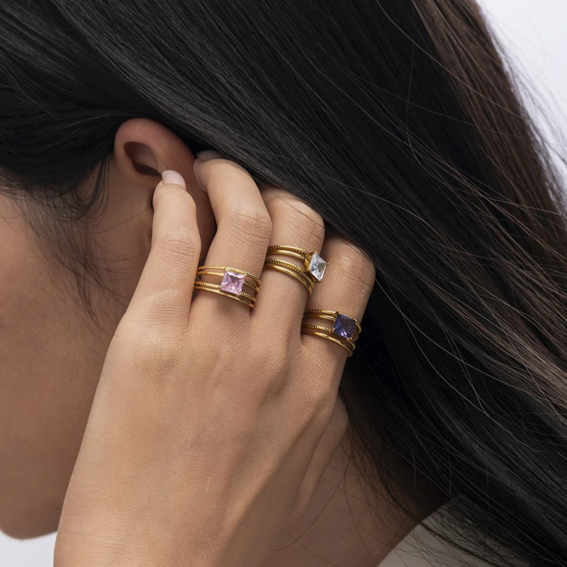 Stacked LIVKE open rings in lavender, clear and deep purple CZ on manicured hand