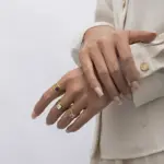 Stacked LIVKE open rings in lavender, clear and deep purple CZ on manicured hand