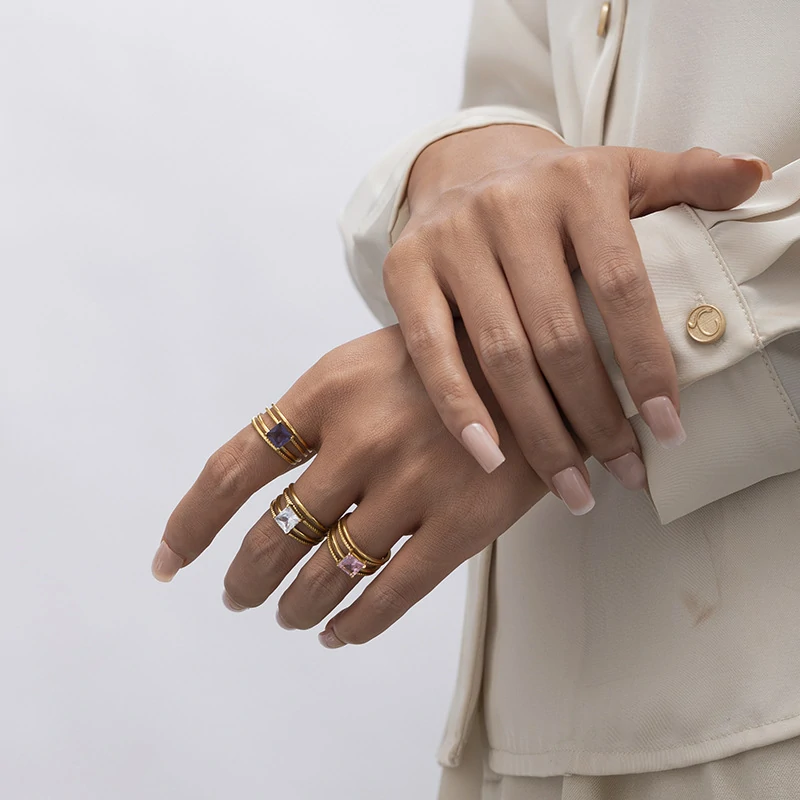 Stacked LIVKE open rings in lavender, clear and deep purple CZ on manicured hand