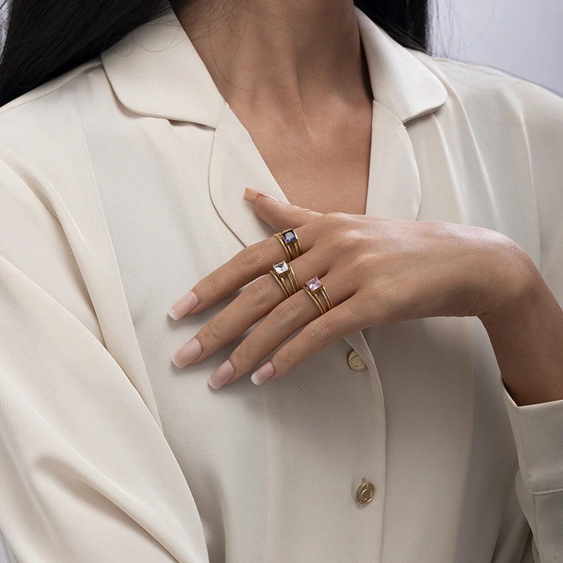 Stacked LIVKE open rings in lavender, clear and deep purple CZ on manicured hand