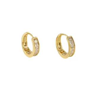 Gold ear cuff with square CZ stones on model's ear catching sunlight