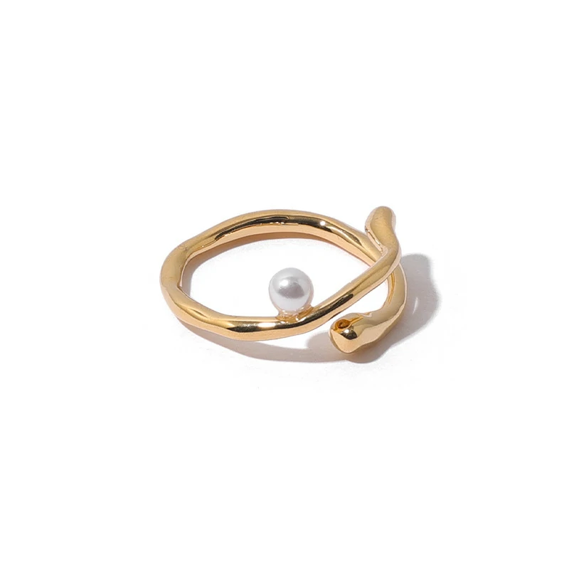 Hand model adjusting open wave ring with pearl under golden hour sunlight