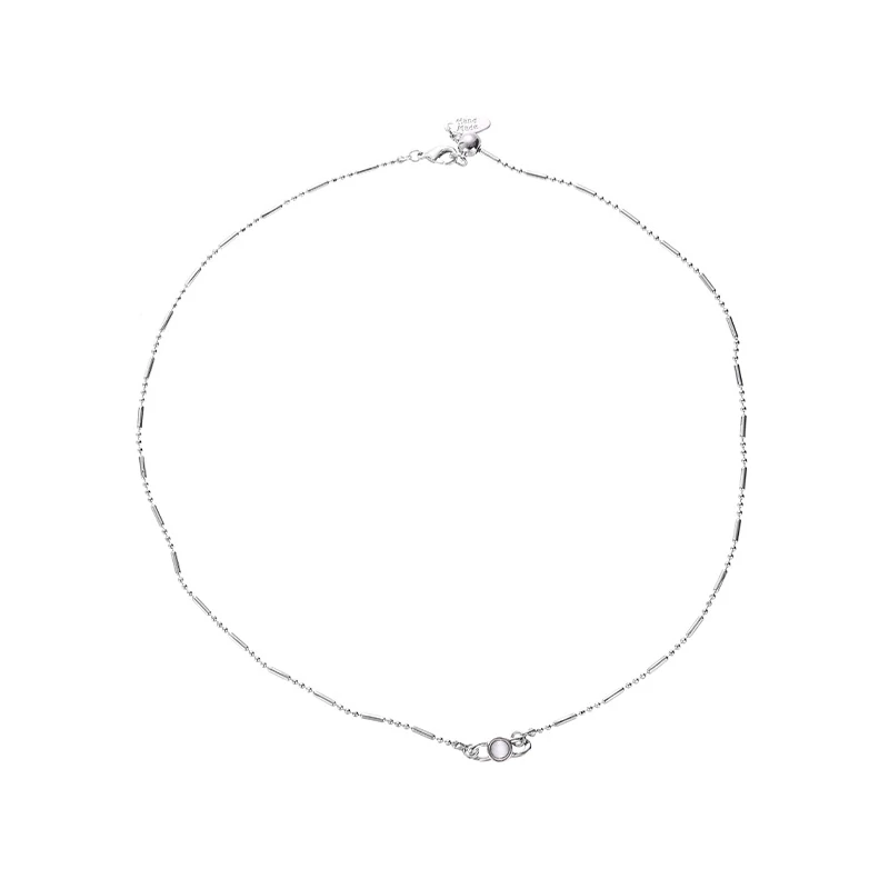 Delicate gold and silver chain set with iridescent shell pendants, perfect for beach weddings and minimalist jewelry lovers