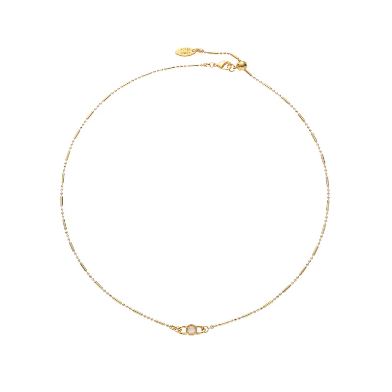 Delicate gold and silver chain set with iridescent shell pendants, perfect for beach weddings and minimalist jewelry lovers
