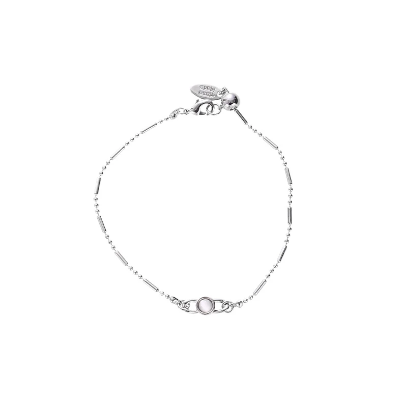 Delicate gold and silver chain set with iridescent shell pendants, perfect for beach weddings and minimalist jewelry lovers